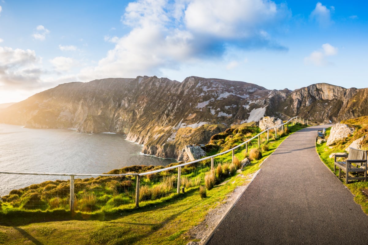 Beautiful Sea view at Slieve League in Ireland Donegal. Great Coast with Rocks and Cliffs at the Background. Sunset and Sunbeams on the road